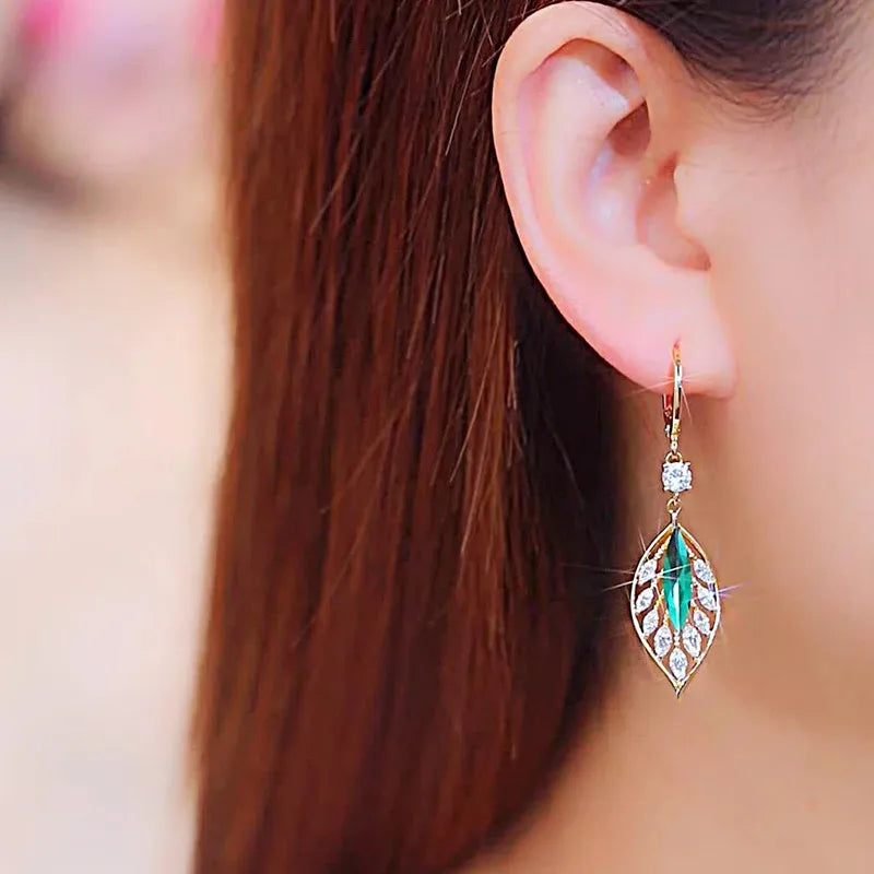 Gold leaf crystal earrings for women featuring green crystals, elegant and stylish jewelry accessory.