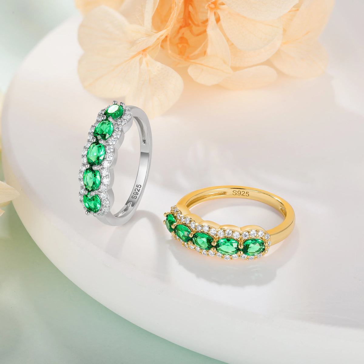 Oval-shaped XCY women's ring with simulated emerald, featuring white gold finish and elegant design.