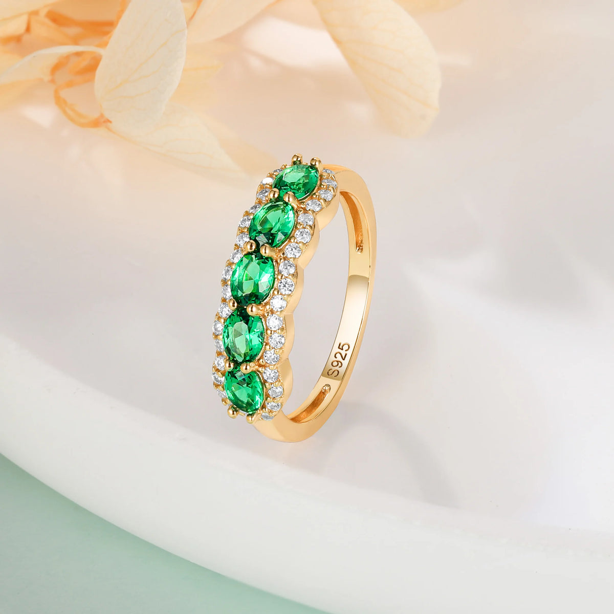 Oval-shaped XCY ring with simulated emerald for women, featuring white gold finish and elegant design.