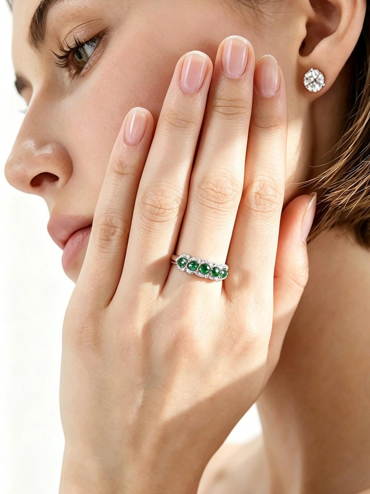 Oval-shaped XCY ring with simulated emerald for women, crafted in white gold with intricate detailing.