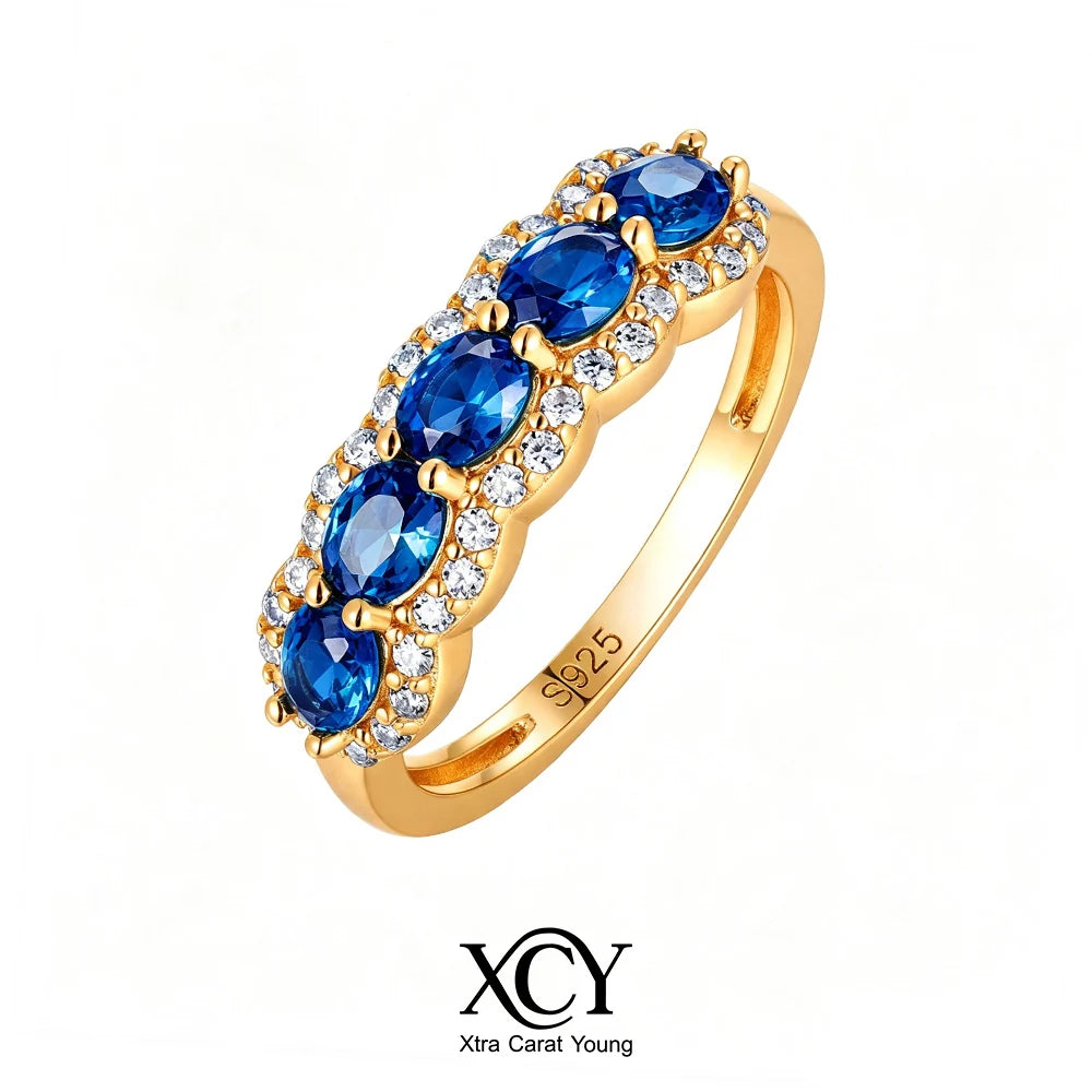 Oval-shaped XCY ring with a simulated emerald for women, gold-plated jewelry featuring a sparkling gemstone.