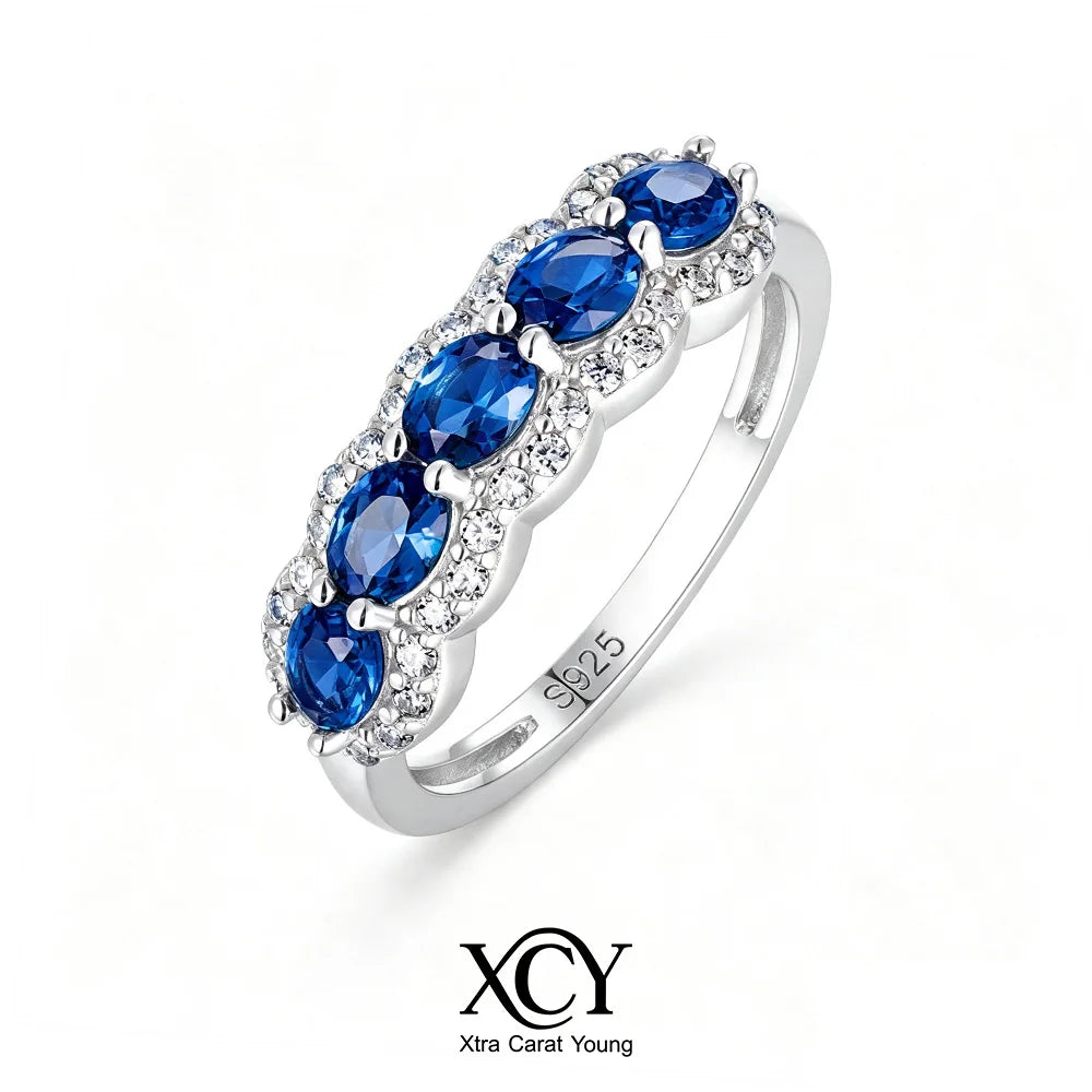 Oval-shaped XCY ring for women with simulated emerald, featuring white gold finish and elegant design.