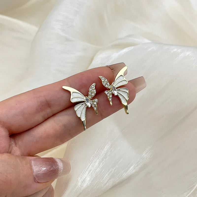 Elegant butterfly-shaped fashion earrings for women, featuring colorful, intricate designs in silver with butterfly motifs.