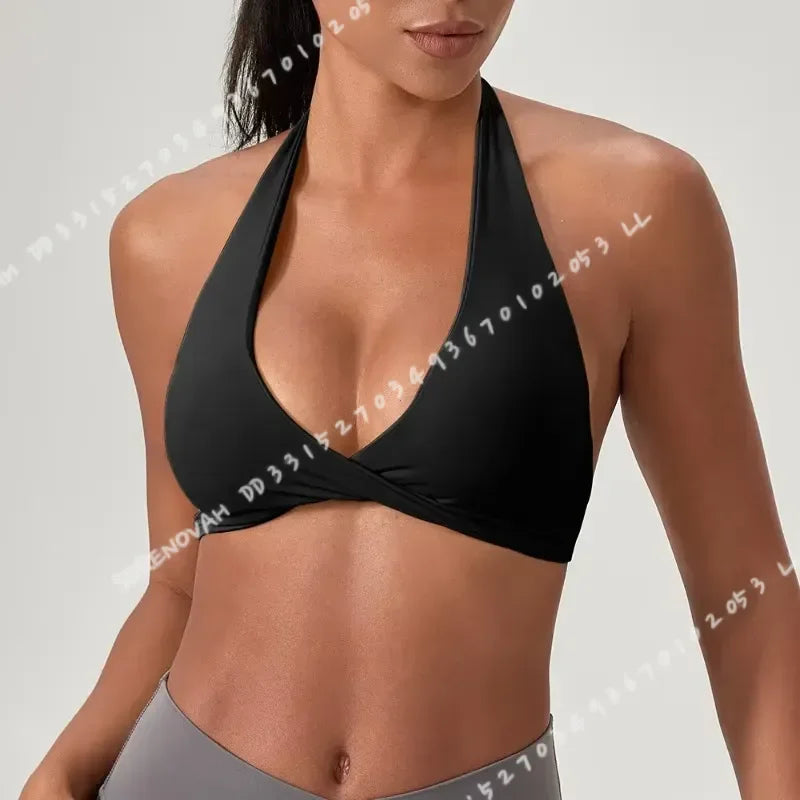 Black yoga sports bra for women with halter neck from Corporación Turística, featuring a comfortable fit and supportive design.