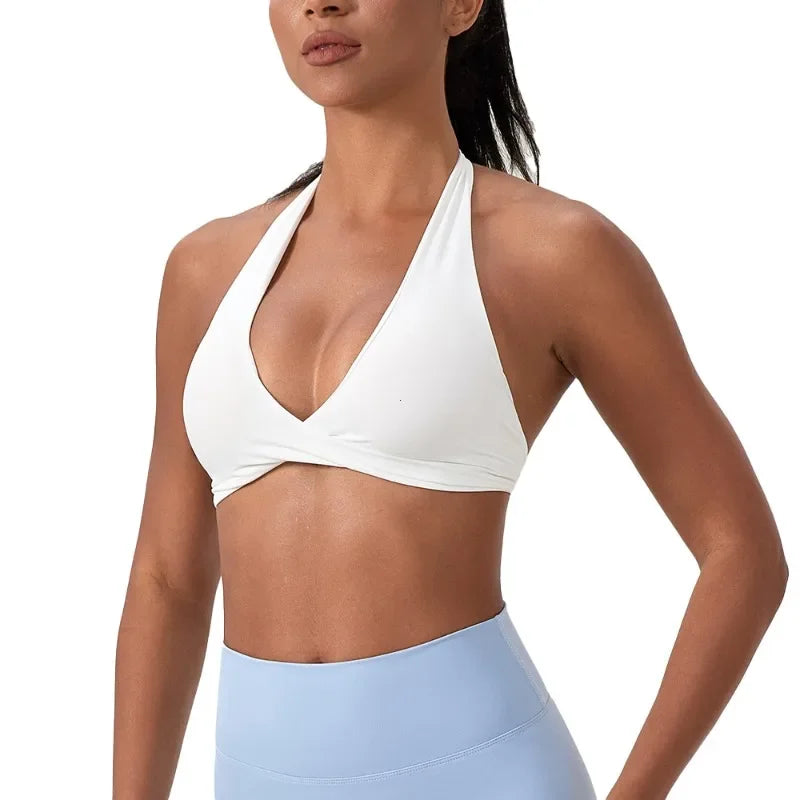 Black women's yoga sports bra with halter neck from Corporación Turística, shown on a white background.