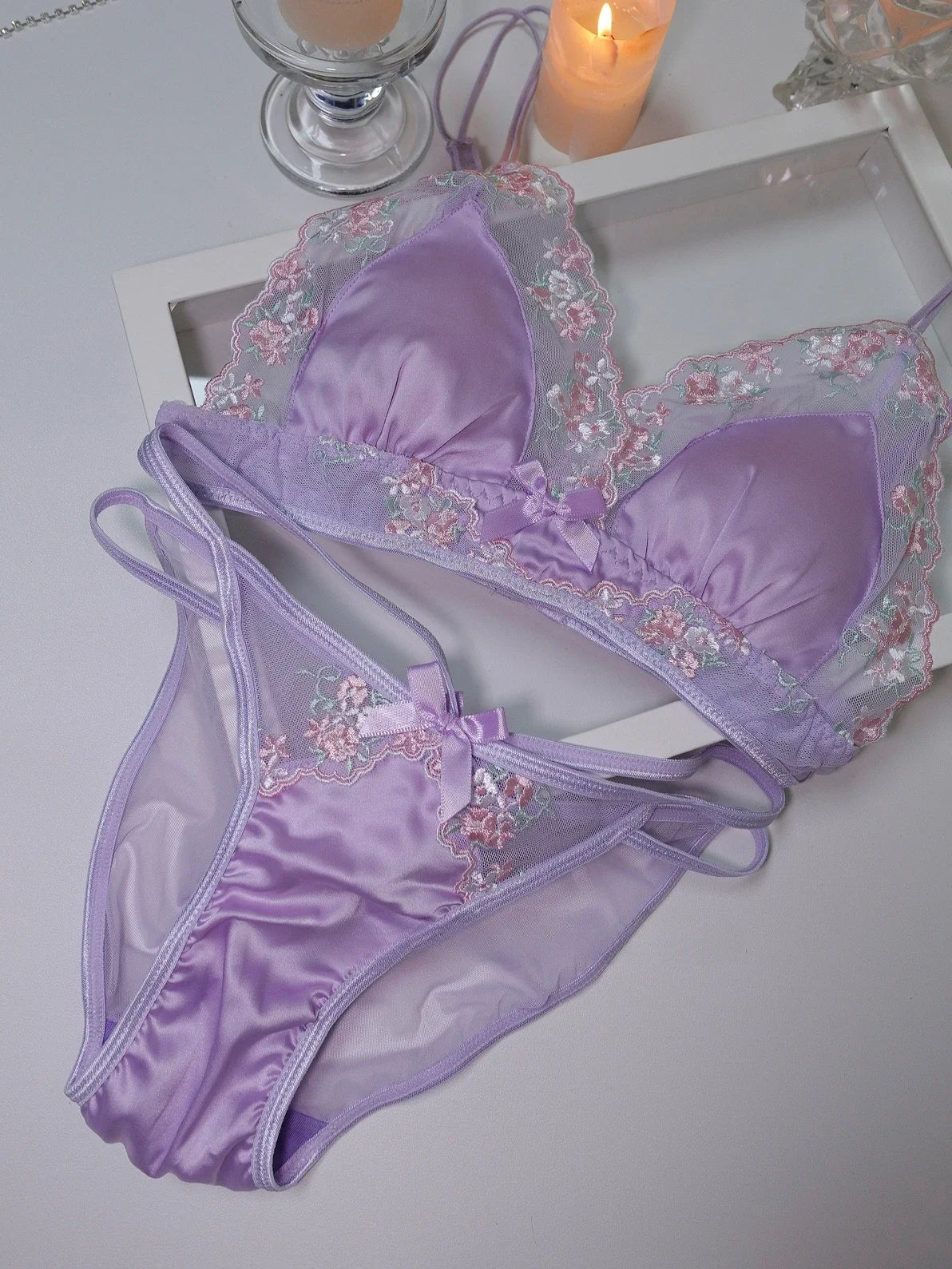 Luxurious light silk lace lingerie set from Corporación Turística, featuring black lace and delicate design.