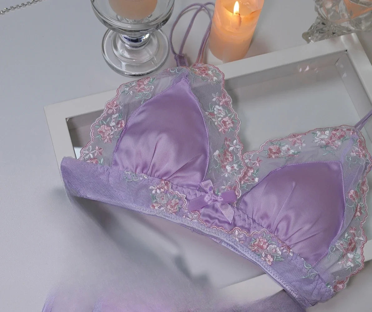 Luxury silk lace lingerie set by Corporación Turística featuring black lace and delicate fabric, displayed on a plain background.