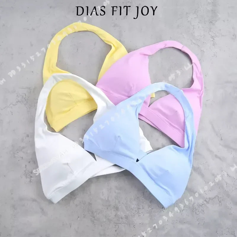 Light blue women's sports bra with halter neck design from Corporación Turística, featuring supportive fit and stylish appearance.