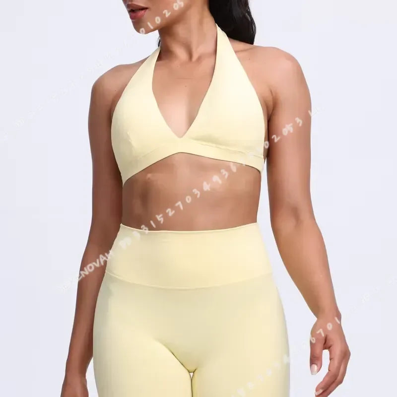 Light blue women's sports bra with halter neck design from Corporación Turística, shown on a white background.