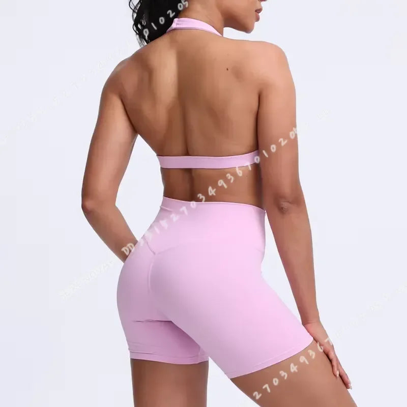 Light blue women's sports bra with halter neckline from Corporación Turística, featuring a stylish and supportive design.