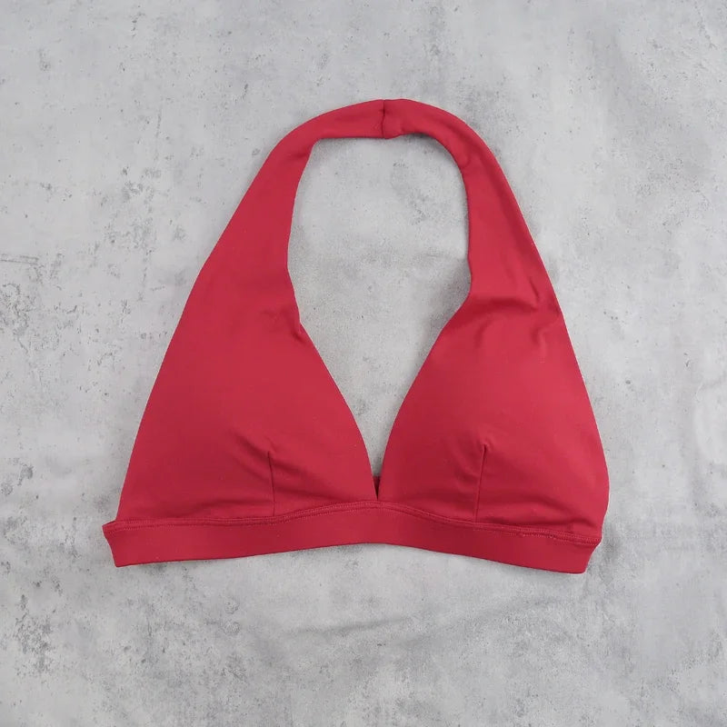 Light blue women's sports bra with halter neckline, from Corporación Turística, featuring a stylish and supportive athletic design.