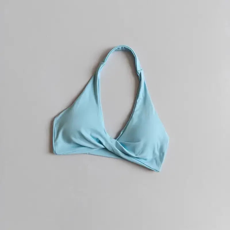 Scarlet red halter sports bra for women with open back from Corporación Turística, shown on a model.