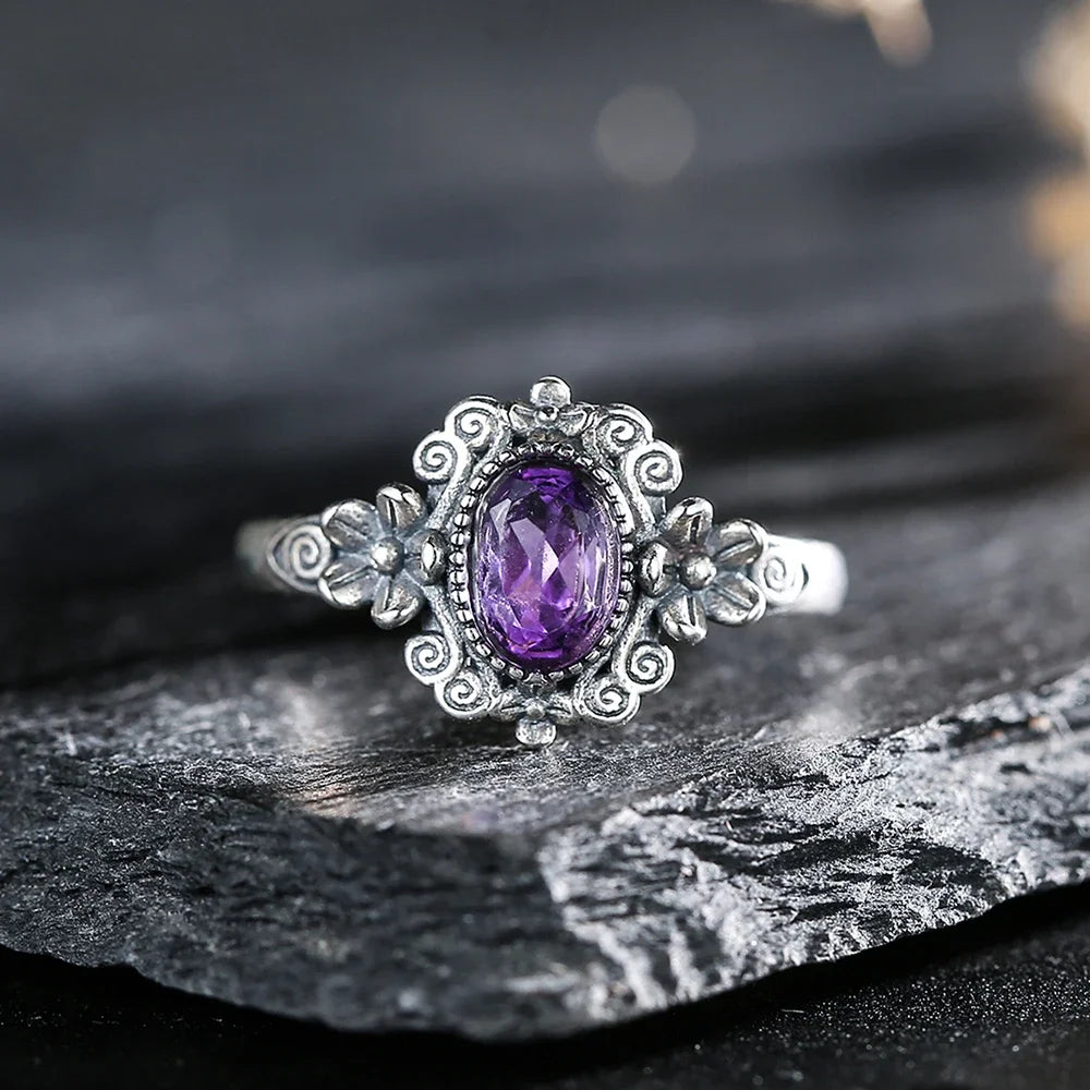 Sterling silver 925 ring with genuine amethyst gemstone, featuring a 7x5mm cut, displayed on a white background.