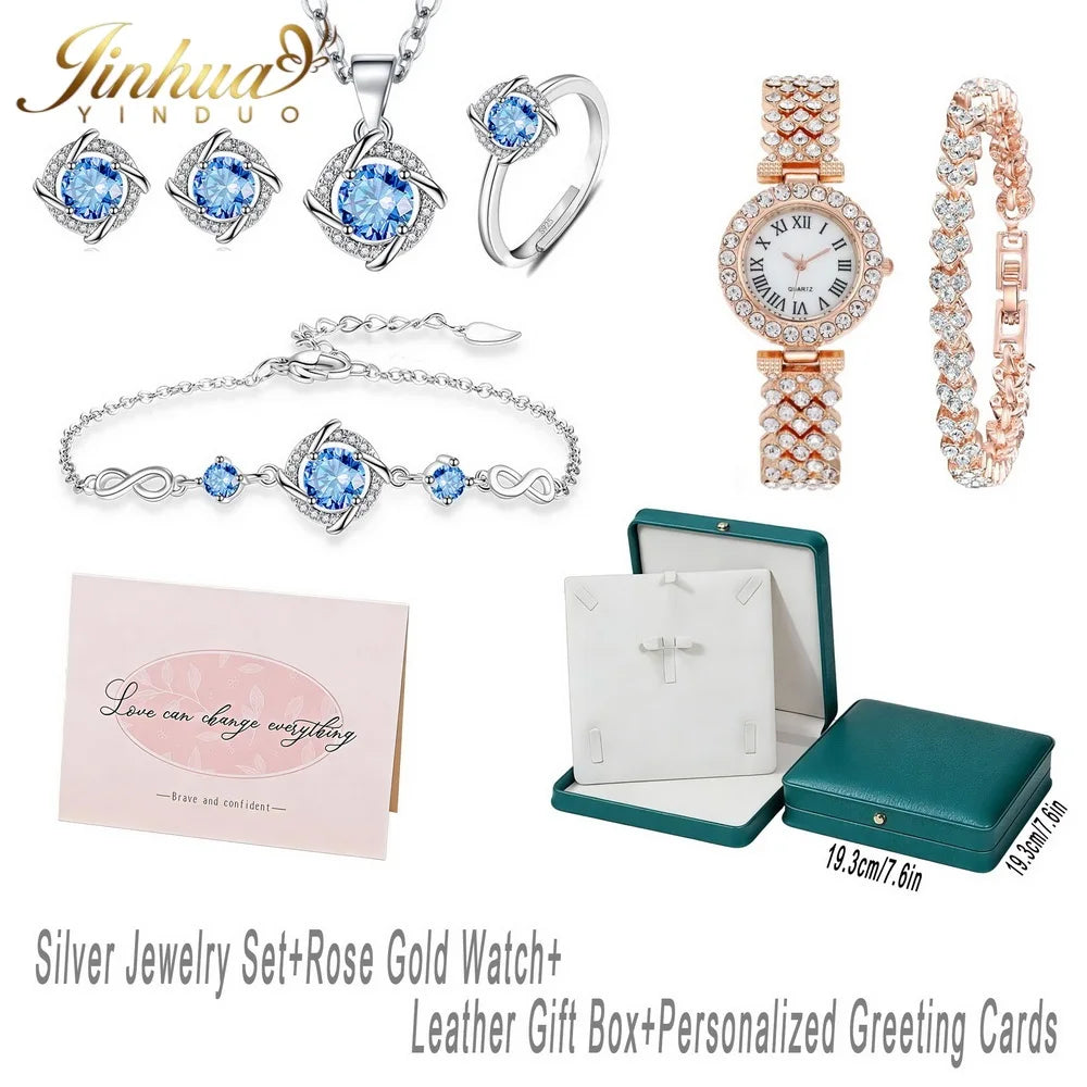 Sterling silver jewelry set with blue stones, featuring classic design and intricate details, displayed on a white background.