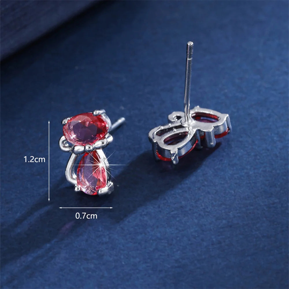 Small green cat-shaped earrings with zirconia stones, crafted by Corporación Turística, featuring delicate feline design and sparkling accents.