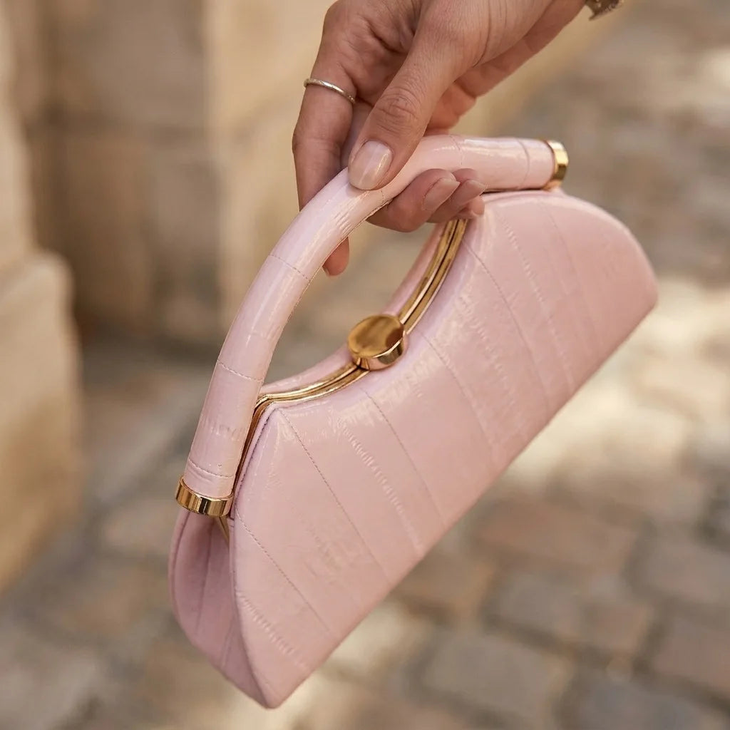 Gold Luna-shaped evening clutch bag for women, stylish handbag with a sleek design by Corporación Turística.