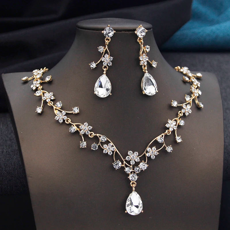 Gold and white water drop-shaped jewelry set for women by Corporación Turística, featuring earrings and necklace with elegant design.