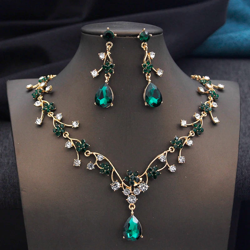 Gold and white water drop-shaped jewelry set for women by Corporación Turística, featuring earrings and necklace with elegant design.
