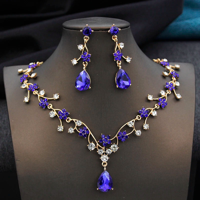 Gold and white water drop-shaped jewelry set for women featuring earrings and necklace from Corporación Turística.