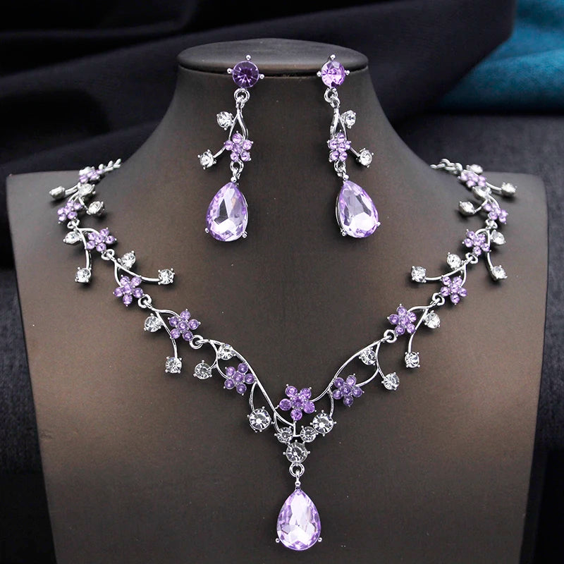 Gold and white water drop-shaped jewelry set for women by Corporación Turística, featuring earrings and necklace with elegant design.