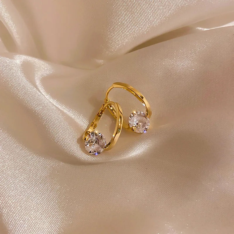 Gold and white Korean fashion zircon pendant earrings with dangling design, perfect for stylish women.
