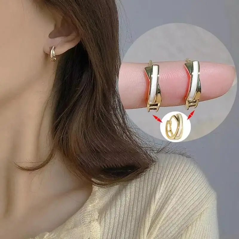 Gold and white Korean fashion zircon pendant earrings by Corporación Turística, featuring elegant hanging design.