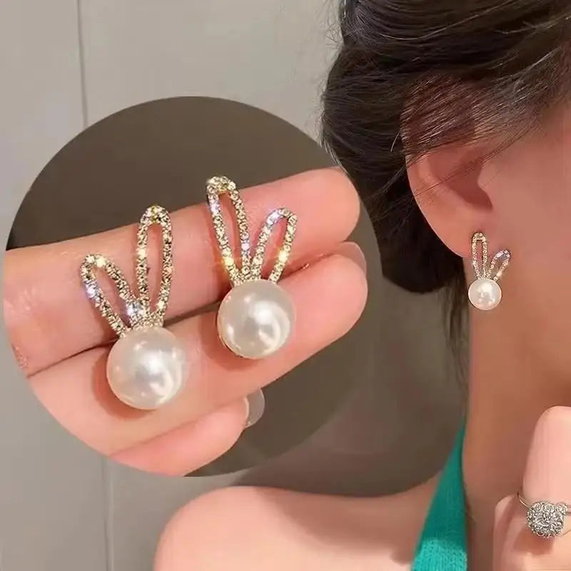 Gold and white Korean fashion zircon pendant earrings with intricate hanging design, perfect for stylish women.