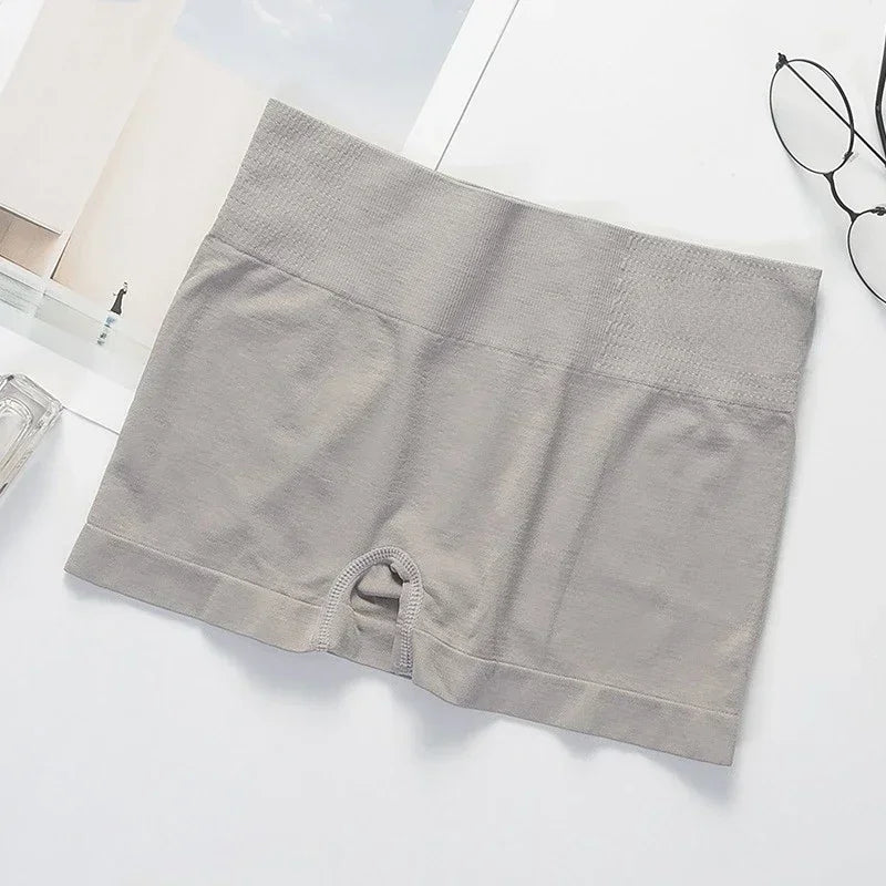 Four pairs of gray women’s slim-fit safety shorts by Corporación Turística, shown folded with elastic waistbands and secure fit.