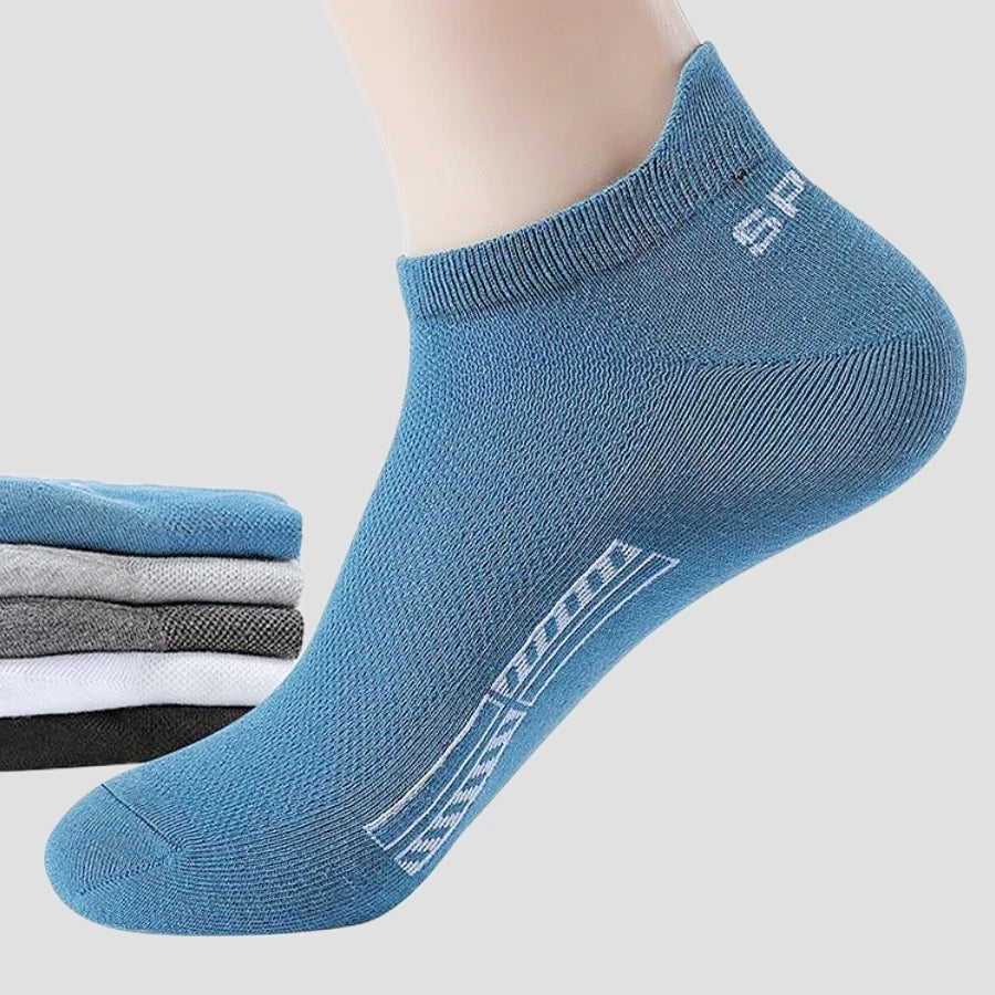 Five pairs of gray high-quality ankle socks for men from Corporación Turística, shown stacked with folded edges.