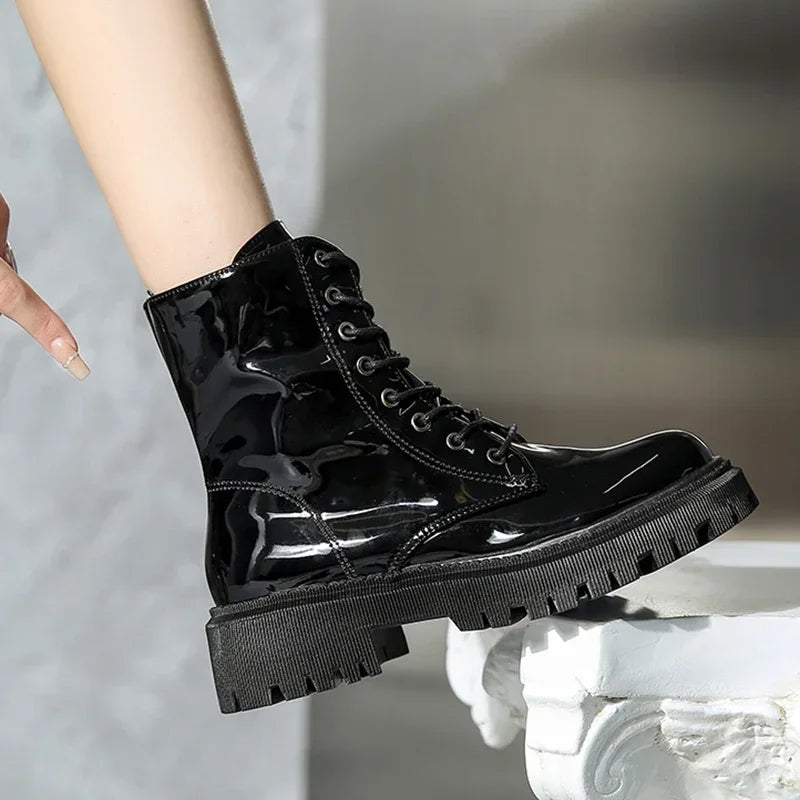 Pink women's lace-up motorcycle boots with a rugged sole, designed for style and durability by Corporación Turística.