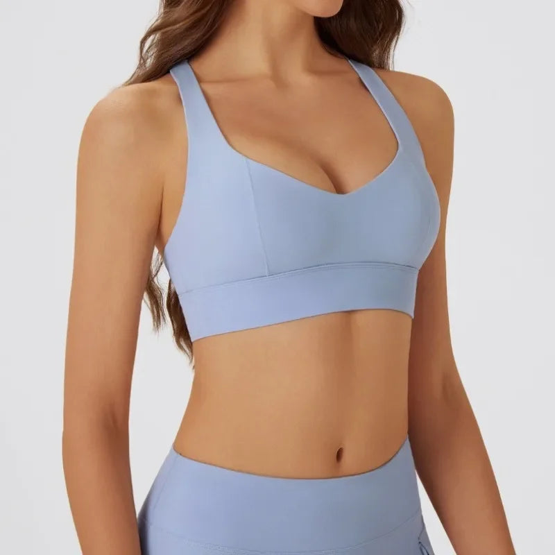 Dark gray women's yoga sports bra with padded cups, designed for comfort and support during yoga and fitness activities.
