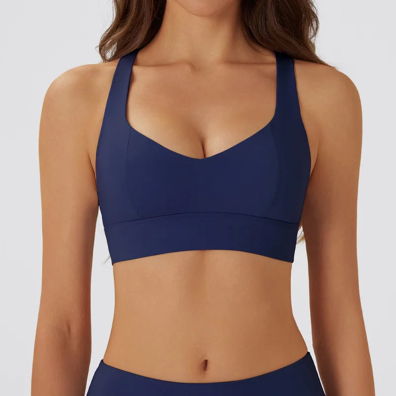 Dark gray women's yoga sports bra with padded cups, designed for comfort and support during exercise.