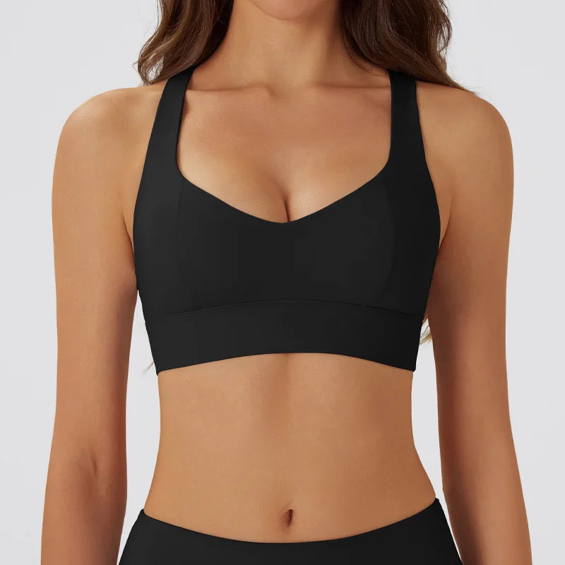 Dark gray women's yoga sports bra with cushioned support, made by Corporación Turística, designed for comfortable activewear.