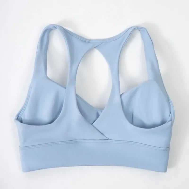 Dark gray women's yoga sports bra with cushioned support, designed for comfortable activewear by Corporación Turística.