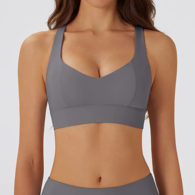Dark gray women's yoga sports bra with padded cups, made by Corporación Turística, suitable for active wear and comfortable support.