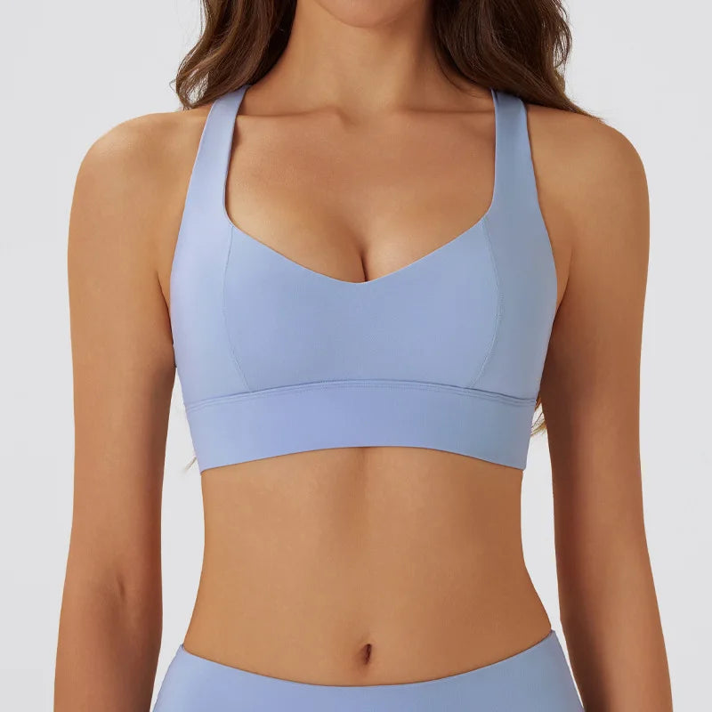 Dark gray women's yoga sports bra with padded support, designed for comfort during exercise.