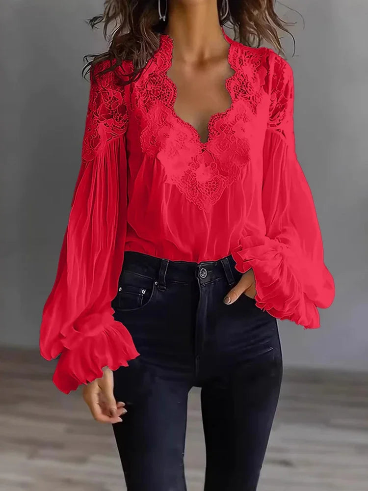 White lace blouse with deep V-neck and long sleeves, from Corporación Turística, shown on a mannequin.