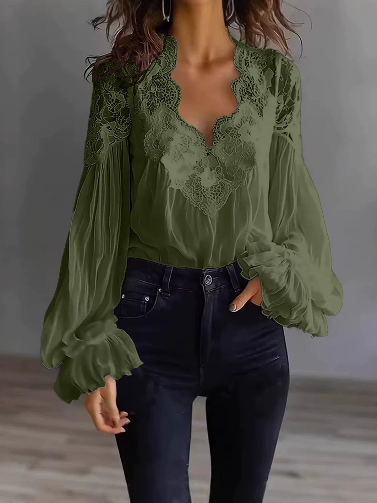 White lace blouse with deep V-neck and long sleeves, from Corporación Turística, showcased on a mannequin.