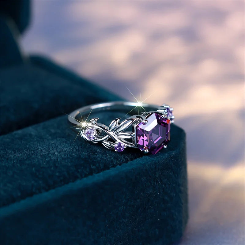 Purple circular ring with hexagonal zircon stones and decorative accents, crafted by Corporación Turística.