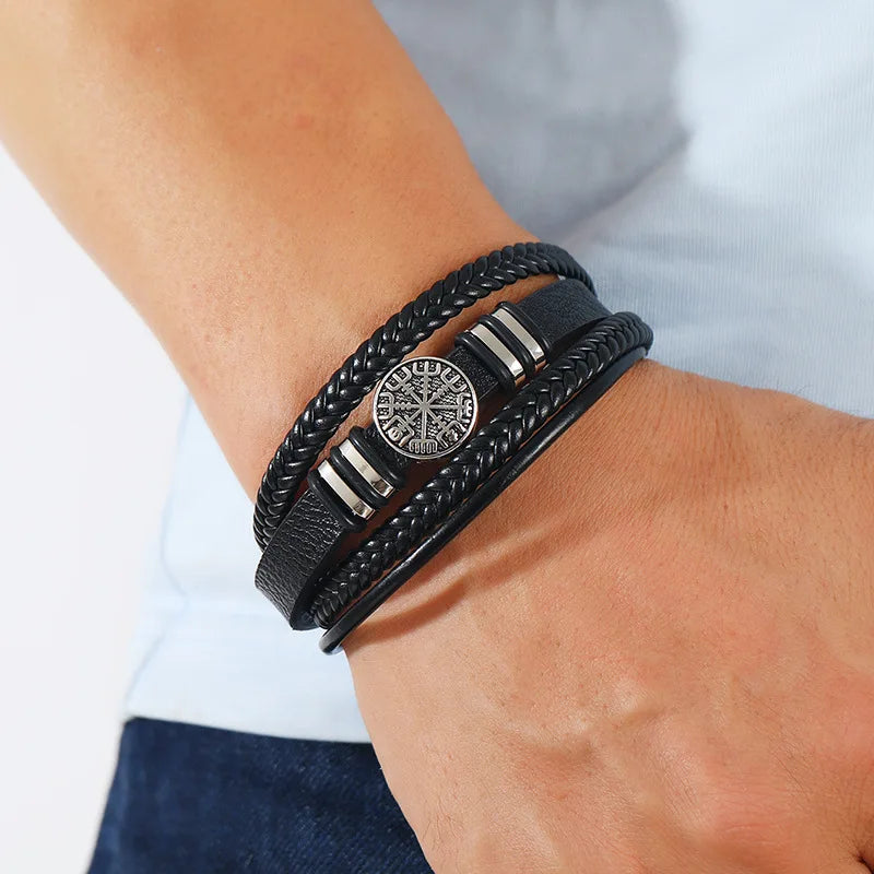 Black men's leather bracelet with multi-layer braid, compass charm, and evil eye bead, 21cm, from Corporación Turística jewelry collection.
