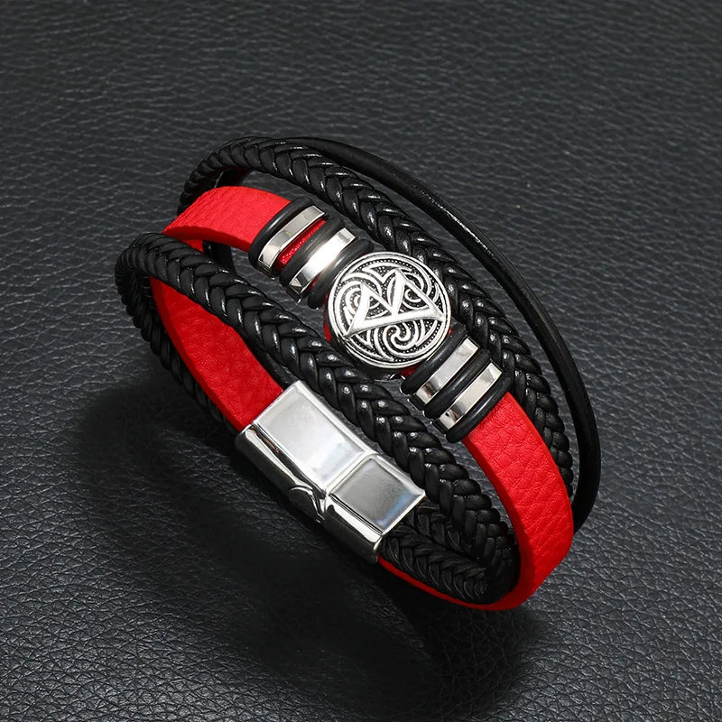 Black leather men's bracelet with multi-layer braid, compass charm, and evil eye bead, crafted by Corporación Turística.