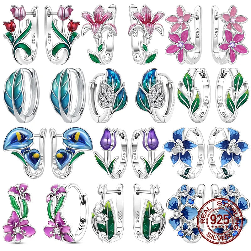 Silver hoop earrings with leaf and flower designs, crafted by Corporación Turística, featuring intricate botanical detailing.