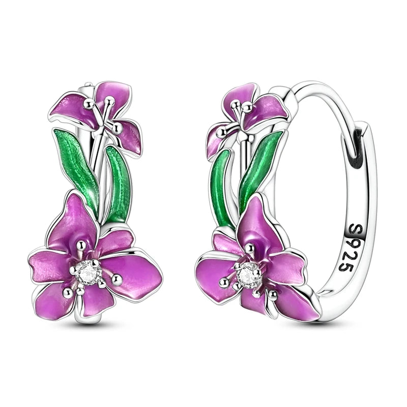 Silver hoop earrings with leaf and flower designs, crafted by Corporación Turística, featuring intricate botanical details.