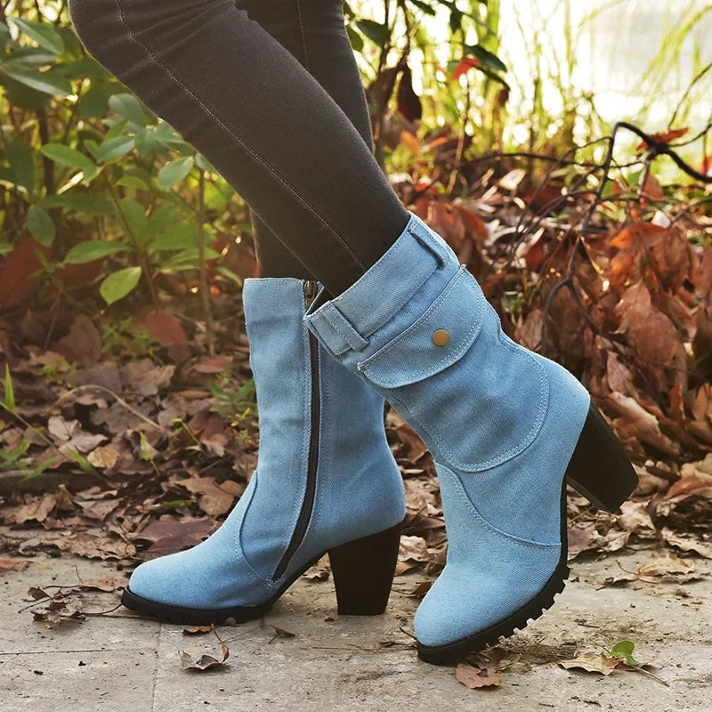 Light blue women's cowboy boots with pointed toes and stacked heels, featuring Western style design from Corporación Turística.