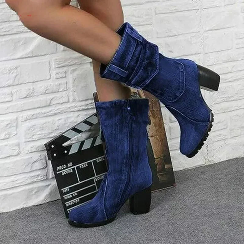 Light blue women's cowboy boots with pointed toes and stacked heels, featuring decorative stitching and a Western style.