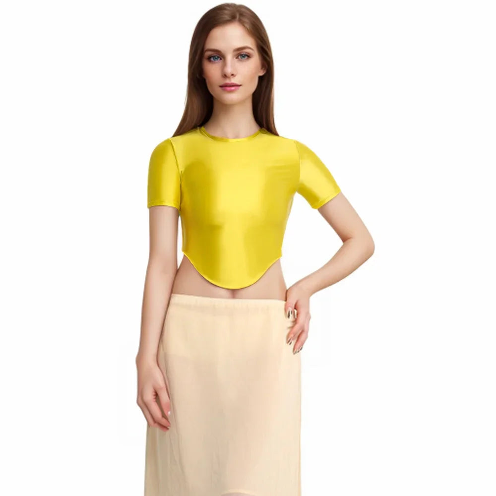 Light purple women's MJINM elastic, shiny, and soft T-shirt by Corporación Turística, shown laid flat with a smooth fabric surface.