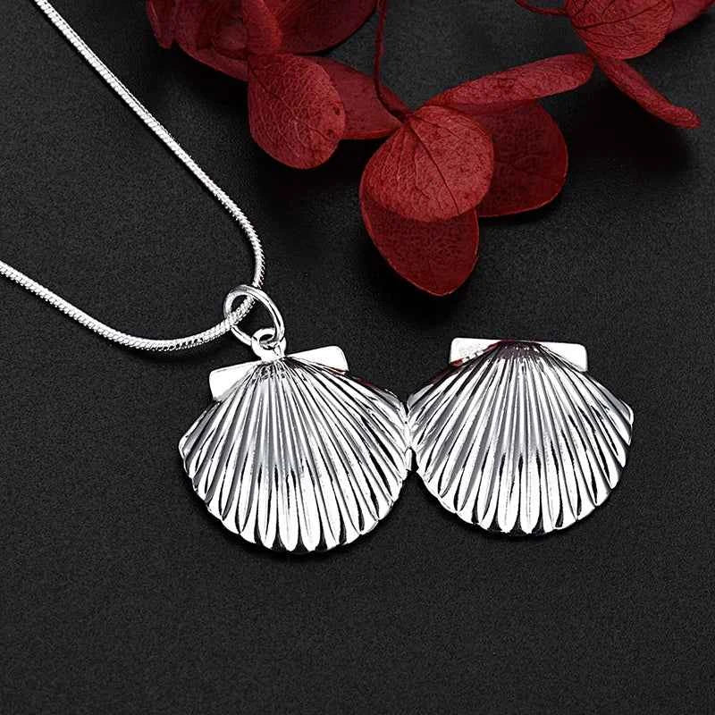 Sterling silver necklace with a shell pendant, 40-75cm length, from Corporación Turística, featuring a detailed shell design.
