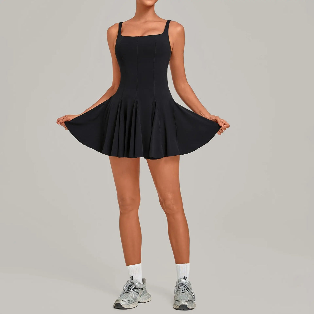 Marfil short sleeveless backless tennis dress with side pockets from Corporación Turística, perfect for active sportswear.