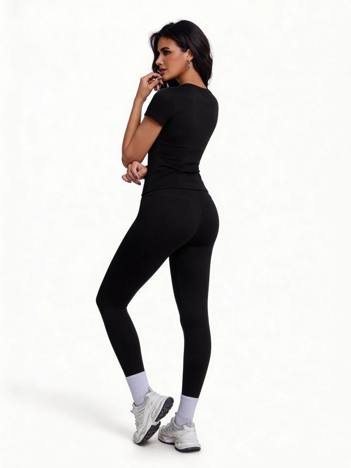 Two-piece women's sports set featuring a marfil-colored T-shirt from Corporación Turística, ideal for active wear.