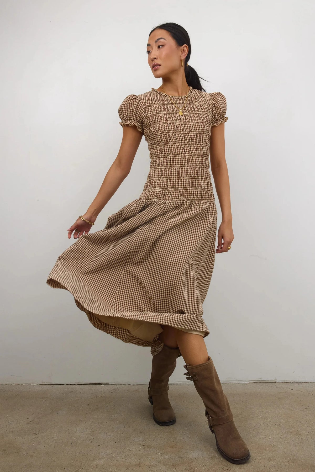 Elegant women's smocked dress with a floral print, featuring a relaxed fit and stylish design, by Corporación Turística.